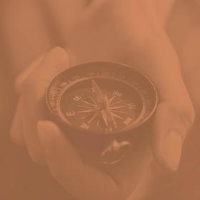 image of a hand holding a compass