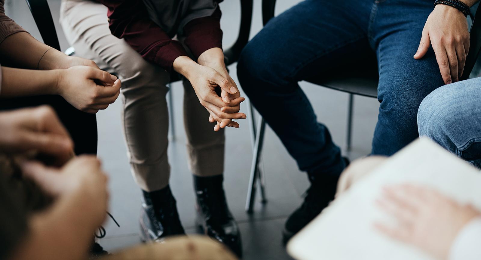 Image of people sitting in a close circle