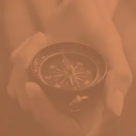 image of a hand holding a compass