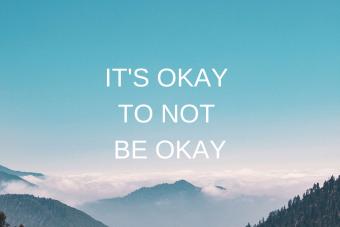 A picture of mountains against a blue sky under words that read "It's Okay to Not Be Okay".
