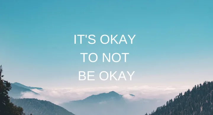 A picture of mountains against a blue sky under words that read "It's Okay to Not Be Okay".