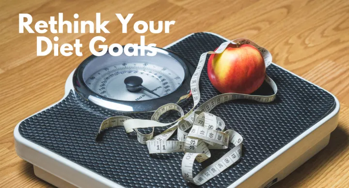 Photo of a scale with an apple and measuring tape with the words "Rethink Your Diet Goals" in the upper left corner